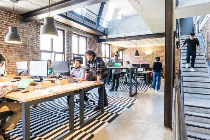 A shot of an active office with everyone at work